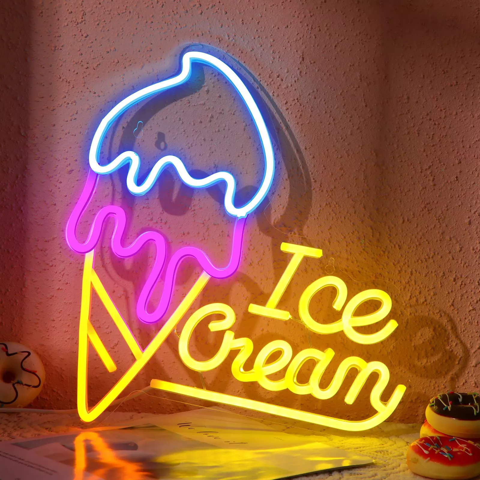 Cream-coloured neon ice cream-shaped LED lights with yellow, blue, and pink illuminated signs